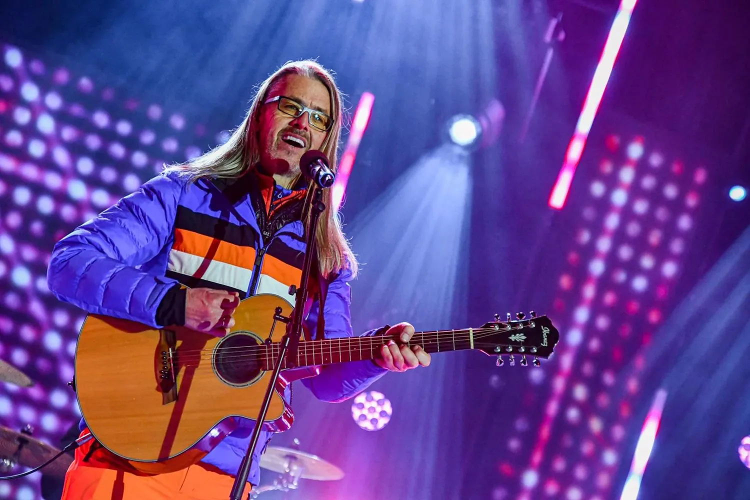 Heli Brunner mit Akustikgitarre am Mikrofon