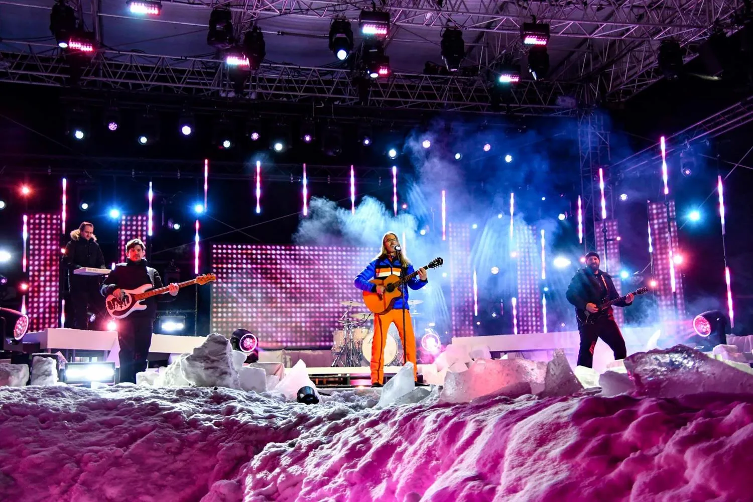 Meilenstein auf einer verschneiten Open-Air-Bühne im bunten Scheinwerferlicht